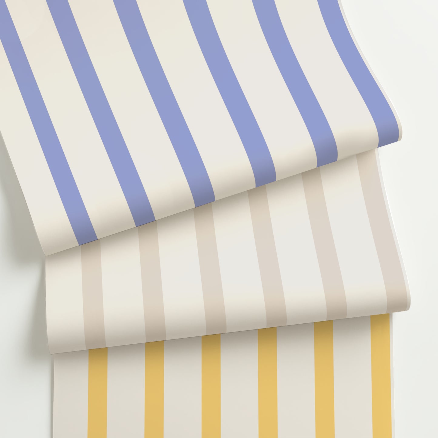 Three rolls of customizable slim scale modern stripe wallpaper in periwinkle blue, soft taupe, and golden yellow on cream, featuring a crisp 2:1 stripe layout.
