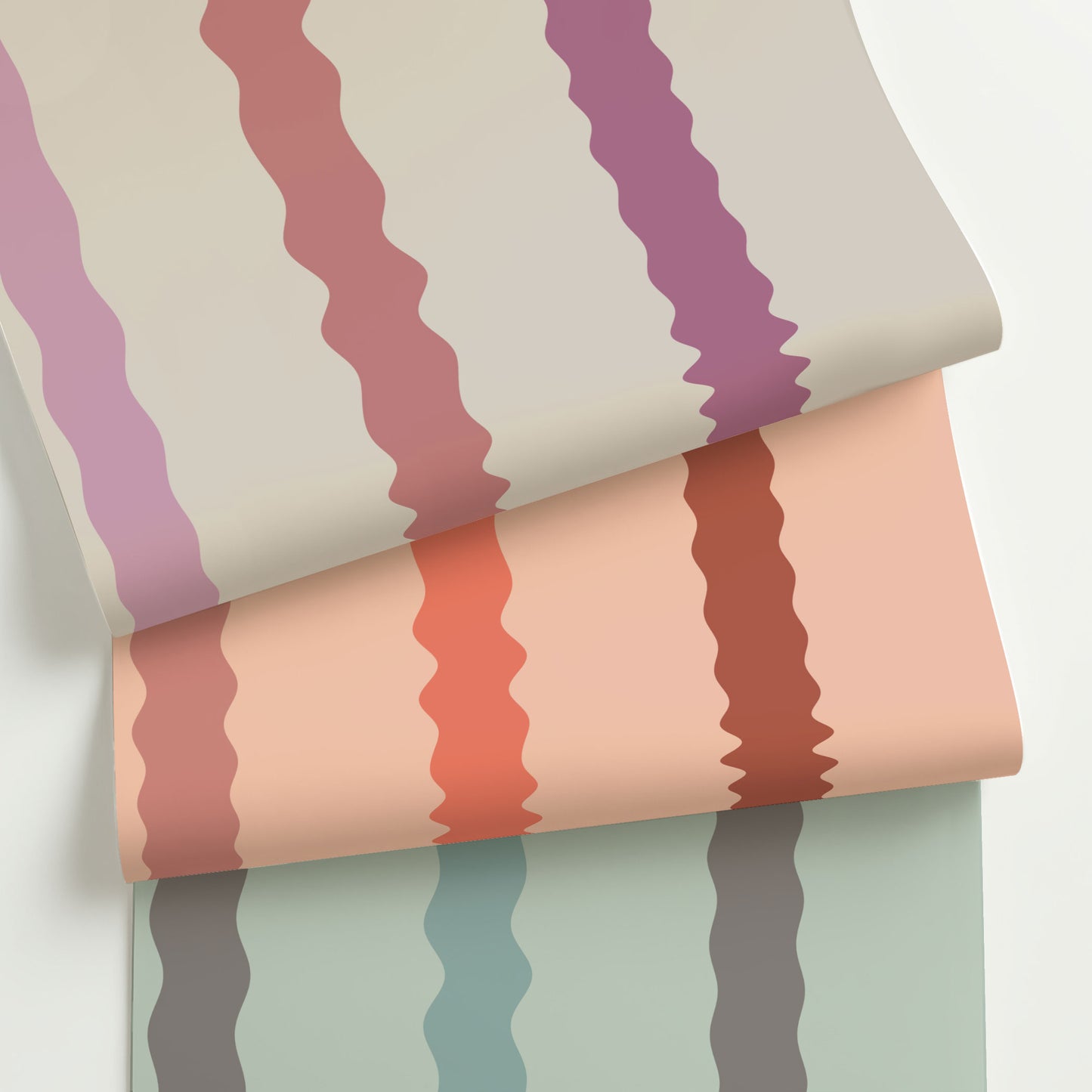 Three colorways of Maiden, a playful wavy stripe wallpaper with hand-drawn curves in warm, modern palettes—rolled to show variety and texture.
