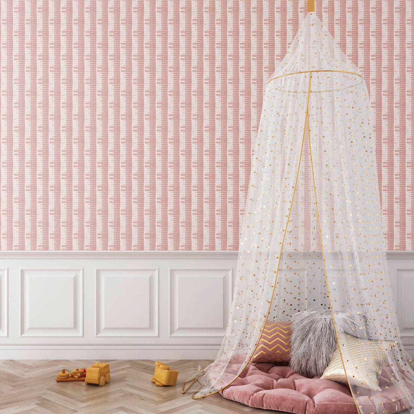 Children's room with a canopy over a pink cushion on the floor against a pink wallpapered wall. Rose Pink striped Shibori Bamboo Wallpaper styled in a light-filled interior space