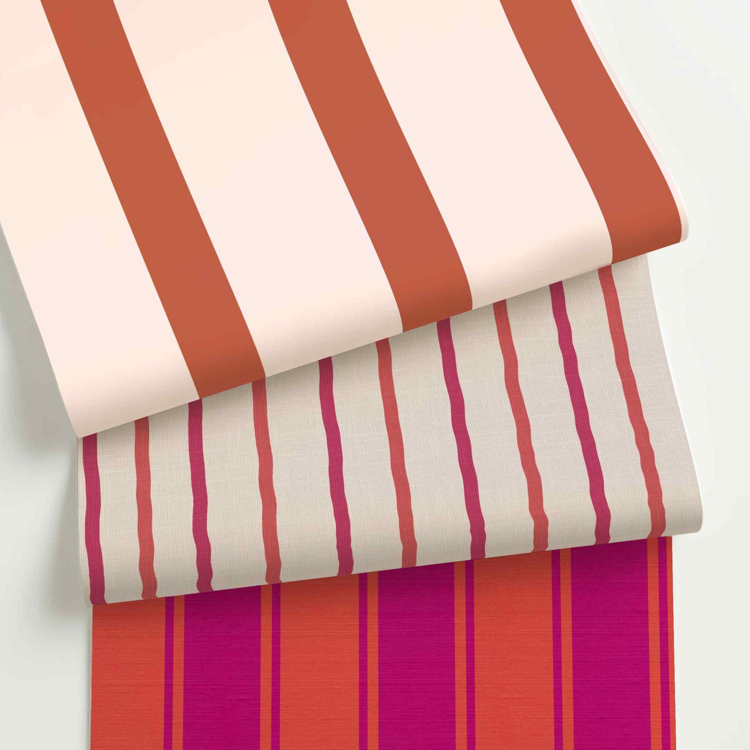 Pink and red striped wallpaper rolls in assorted colors, scales, and stripe patterns.