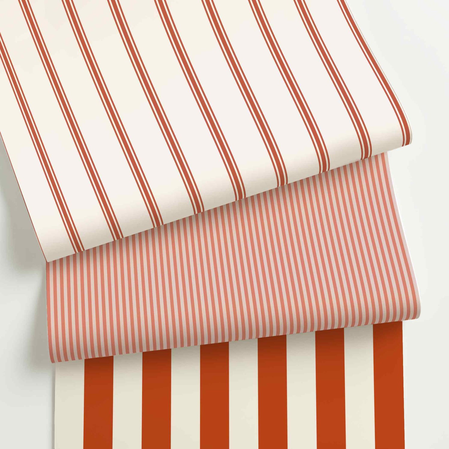Red and white striped wallpaper rolls in assorted colors, scales, and stripe patterns.