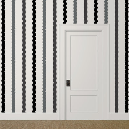 Wavy black, grey, and white striped wallpaper in a playful modern hallway