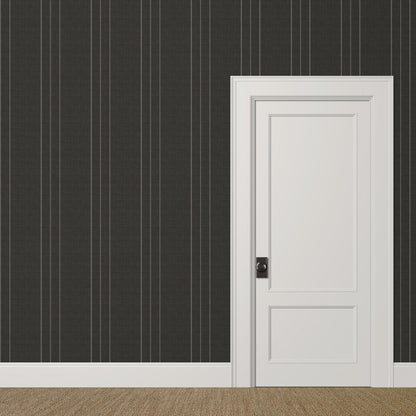 Medium-scale black and grey pinstripe wallpaper with linen finish in a modern study with art on display