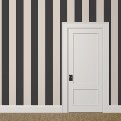 Large-scale black and off white striped wallpaper with sepia tone in a grand staircase interior