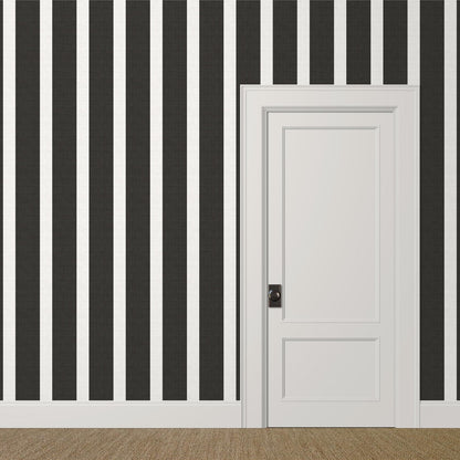 Large-scale black and white striped wallpaper with linen finish in a modern entry hall