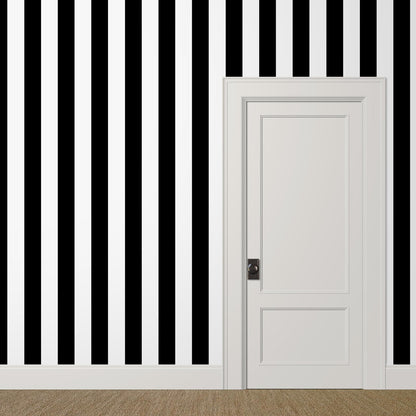 Bold black and white striped wallpaper in a room with white trim