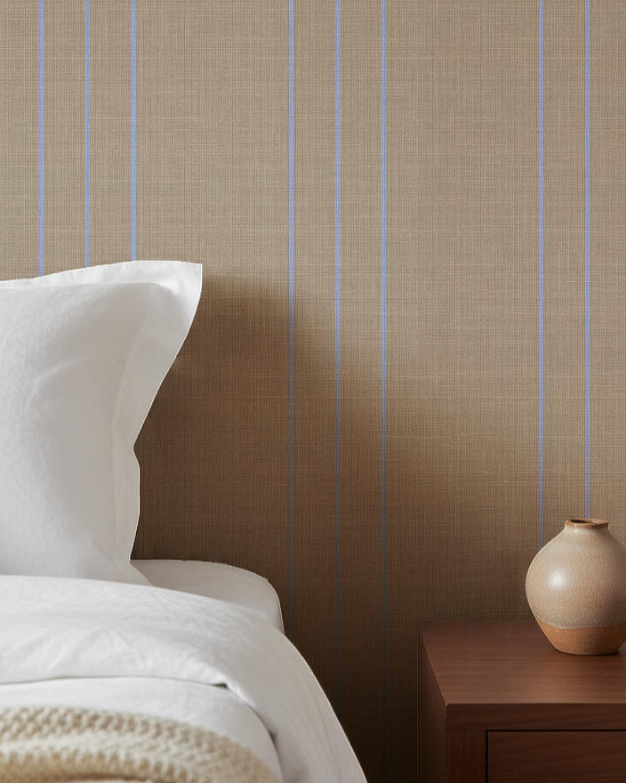 Linen finish striped wallpaper with blue pinstripes in a bedroom interior demonstrating one of the wallpaper finishes available