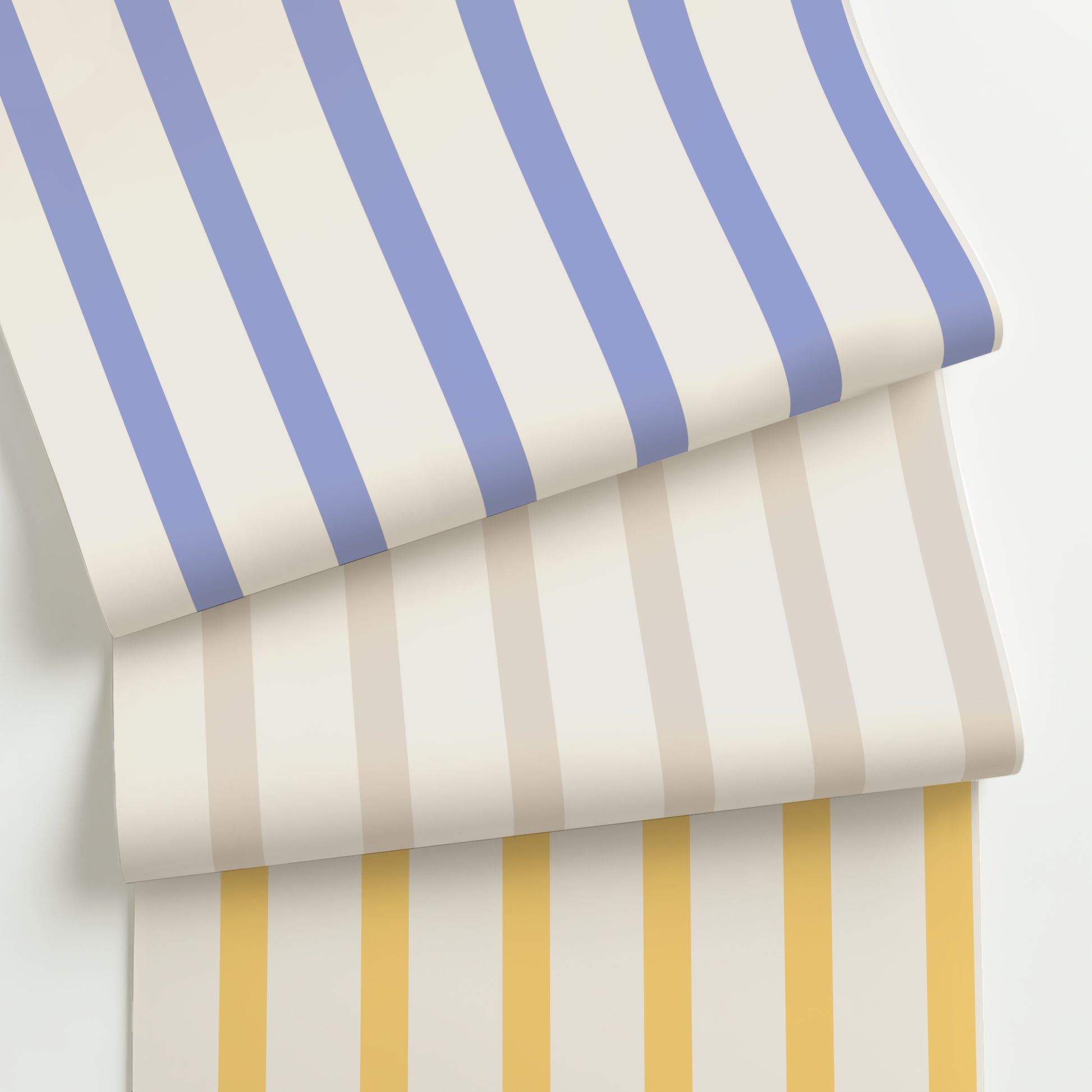 Three rolls of customizable slim scale modern stripe wallpaper in periwinkle blue, soft taupe, and golden yellow on cream, featuring a crisp 2:1 stripe layout.