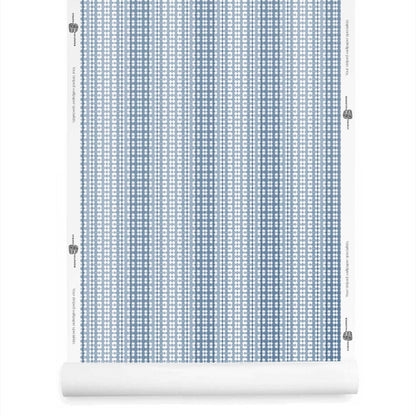 Roll of dusty blue ombre wallpaper with stripes, hand-dyed style and soft geometric contrast.