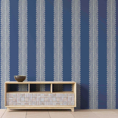 Lapis blue bohemian striped wallpaper in a creative living room with bold, artistic style and crisp white stripes